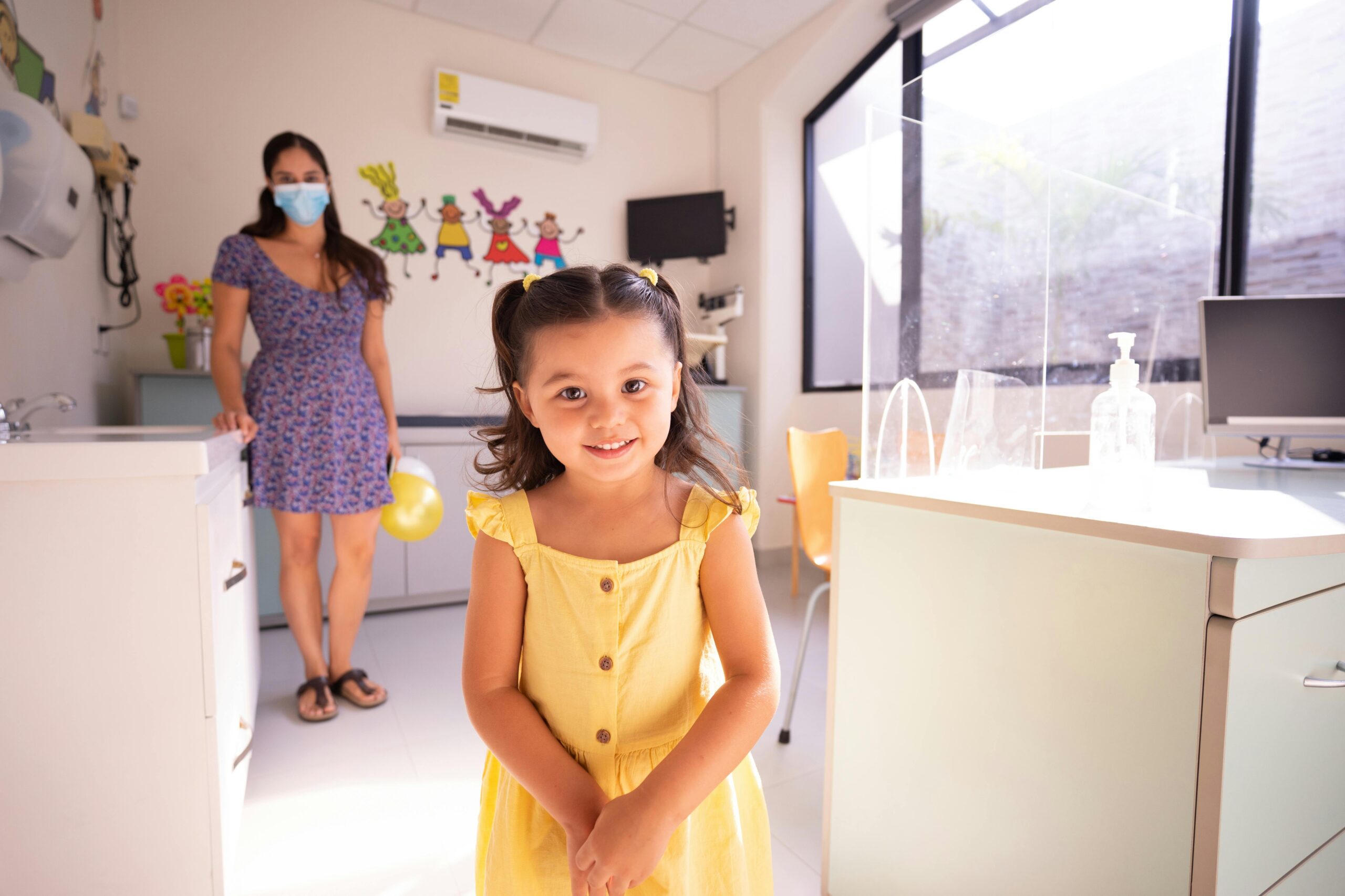 Girl at doctor's office in yellow dress